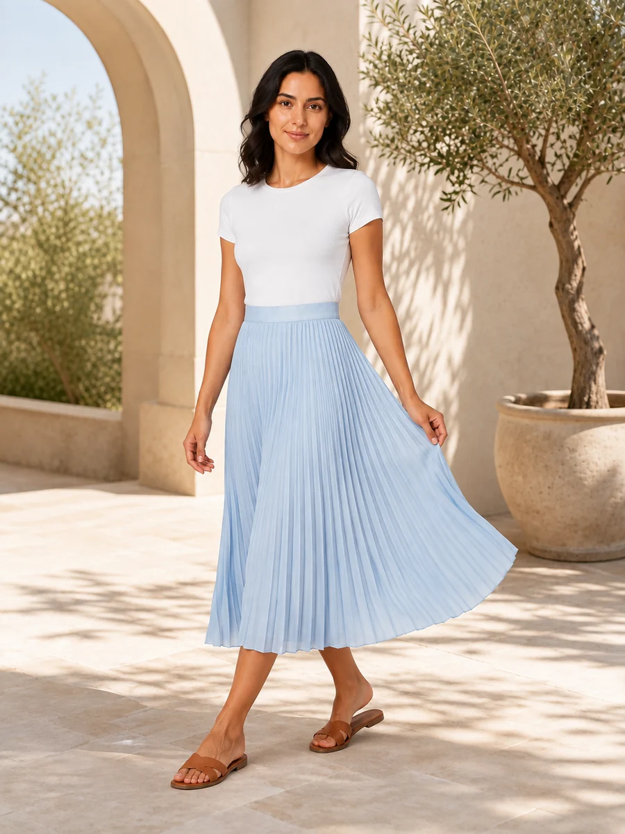 Blue pleated skirt look in a new editorial pose